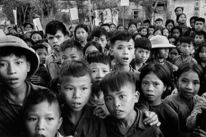 Vietnam, 1969. In a isolated village in North Vietnam, these schoolchildren stare at me as they leave the classroom, their curiosity mixed with alarm - I was probably the first Europeans they had ever seen.