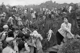 Japan, 1958. Japan's first photography festival. Models provided by Fuji pose at the volcanic site of Karuizawa to the great delight of amateur and professional photographers.