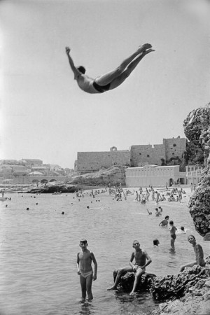 Yougoslavia, 1953. A man diving in front of Dubrovnik walls.