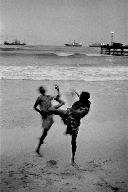 Ghana, 1960. Two boys on the beach in Accra in the evening. Are they fighting or inventing a new dance?