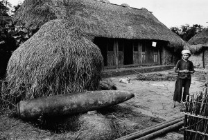 Bomb fallen in the courtyard of a farming cooperative in the area of Phat Diem, 1969
