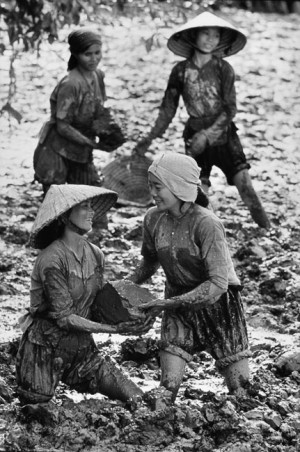 These women clear out an irrigation canal that was filled by mud with their bare hands, 1969