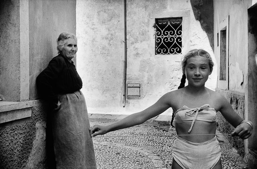 A girl wearing a "bikini" in the streets of Dubrovnik, under the eye of her grandmother, 1953